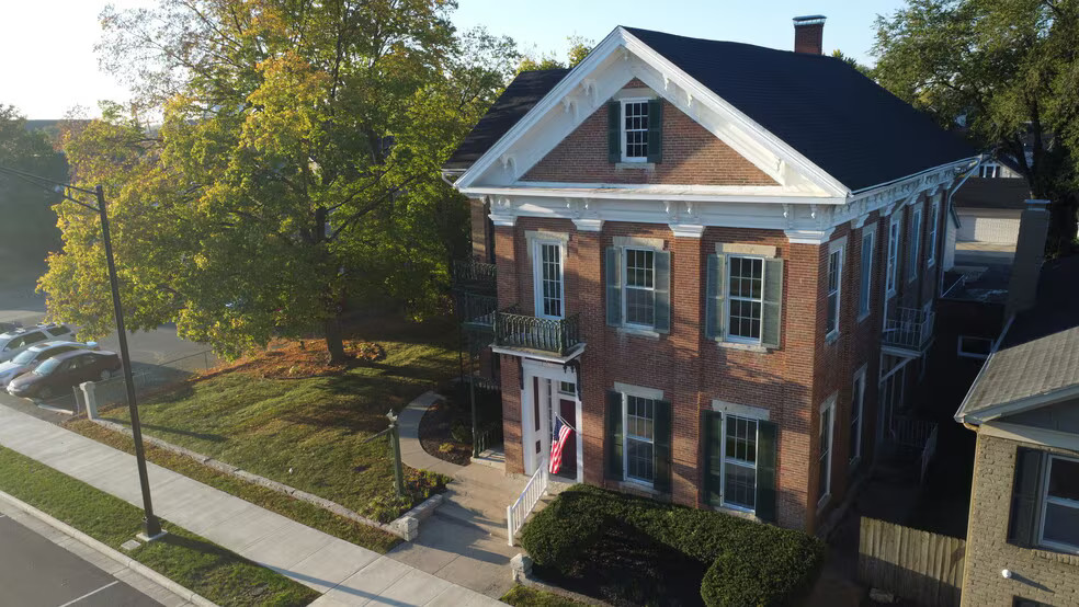Aerial view of the historic brick building at 314 W Main St with autumn trees