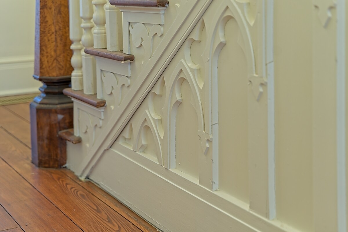 Close-up of ornate Gothic-style carved staircase woodwork