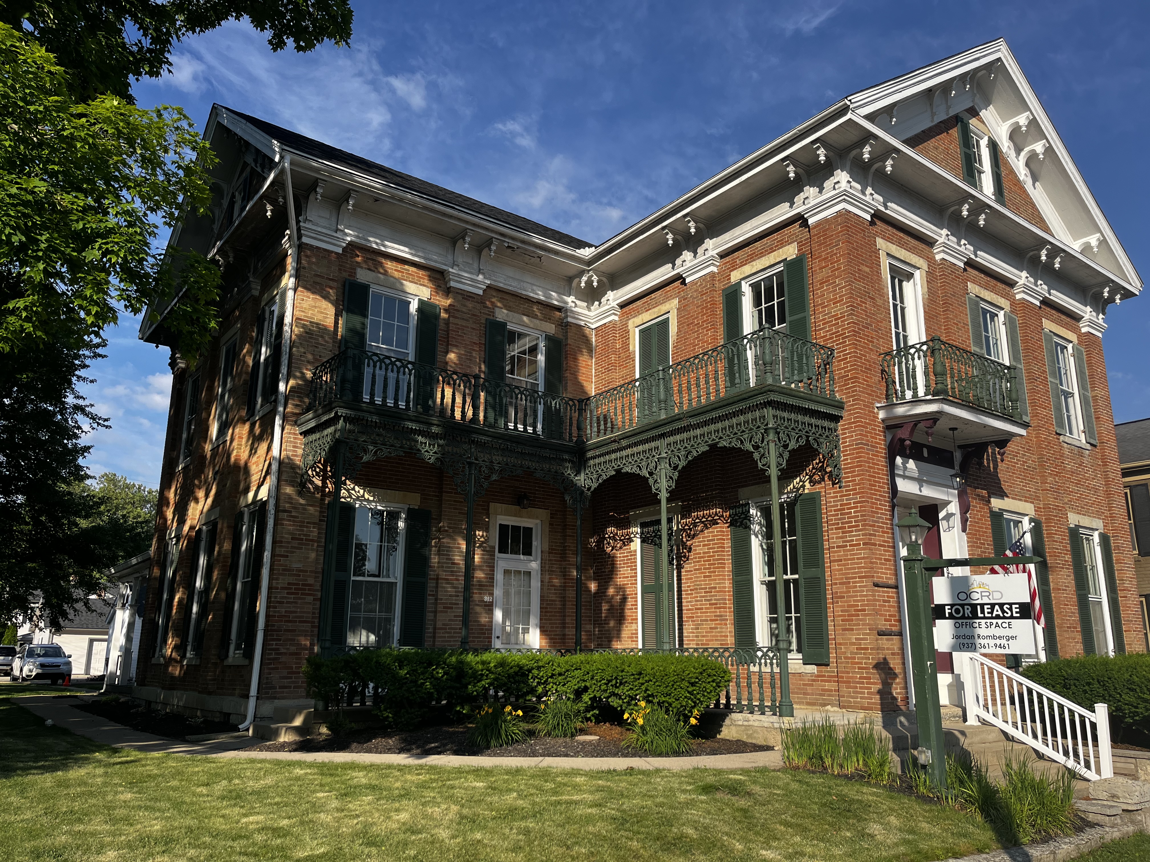 314 W Main St historic brick exterior with Victorian ironwork balconies